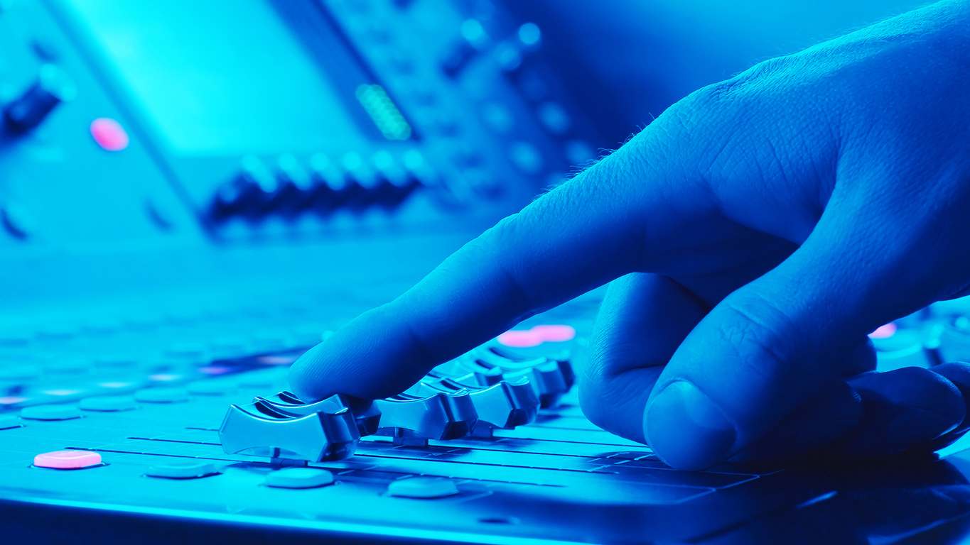 Finger Sliding Audio Mixer Fader On Sound Console Macro | Marketing Direction | Digital Marketing Agency | Tampa - St Pete FL Hand adjusting controls on an audio mixing board, representing how AI amplifies existing marketing strategy